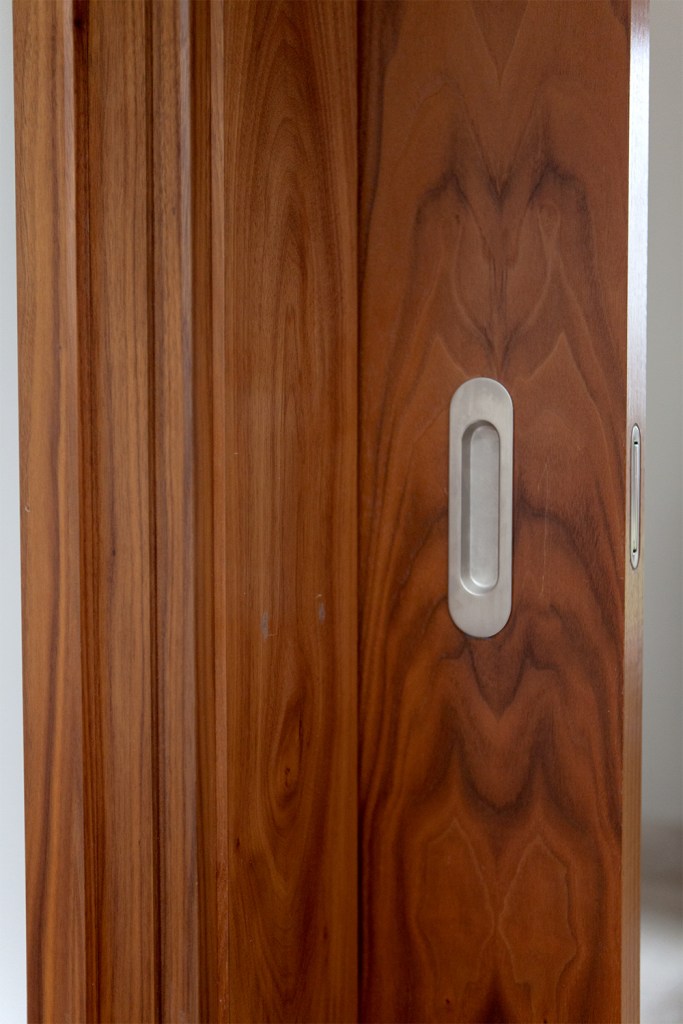 Flush door handle for sliding door - dark stained wood door - flush latch