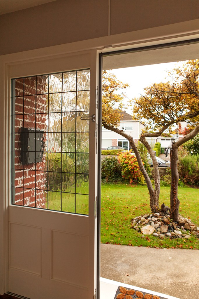 view to garden - white door frame - white window frame - garden - tree - front door