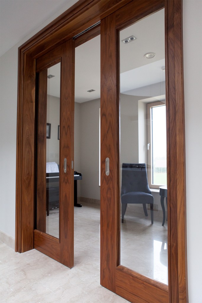dark wood sliding double door - stained wood - doorlight - wood door frame -