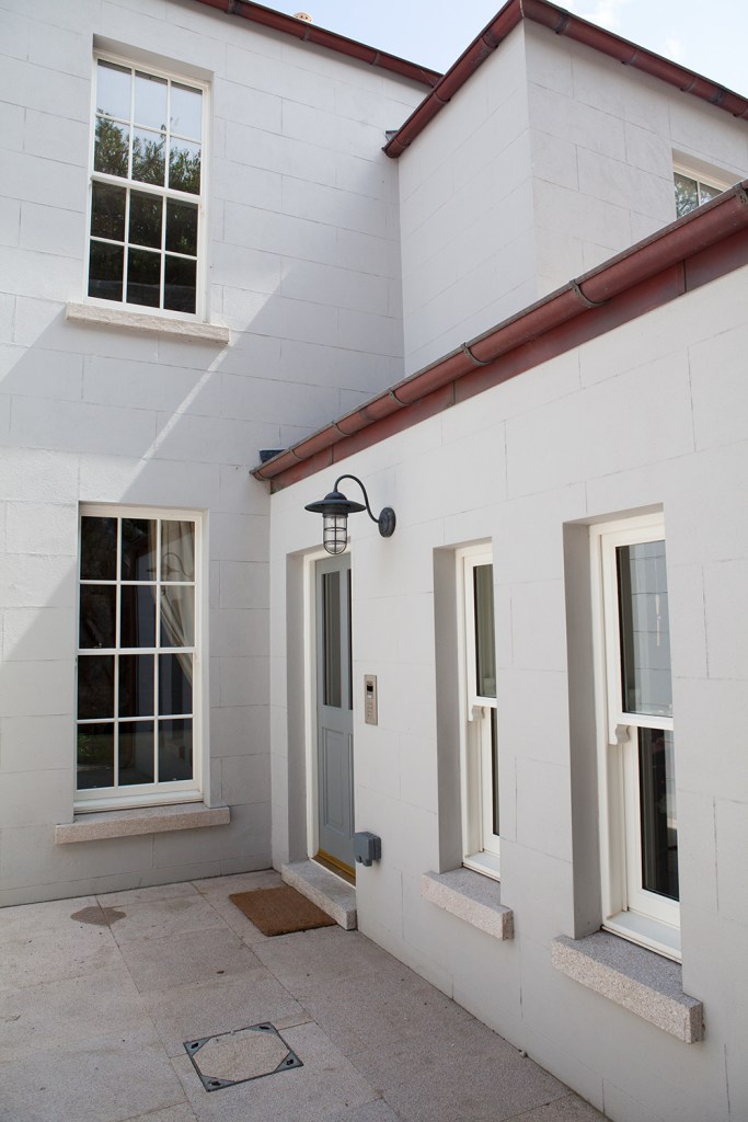 double hung window - window grille - white window frame - window apron - roof gutters