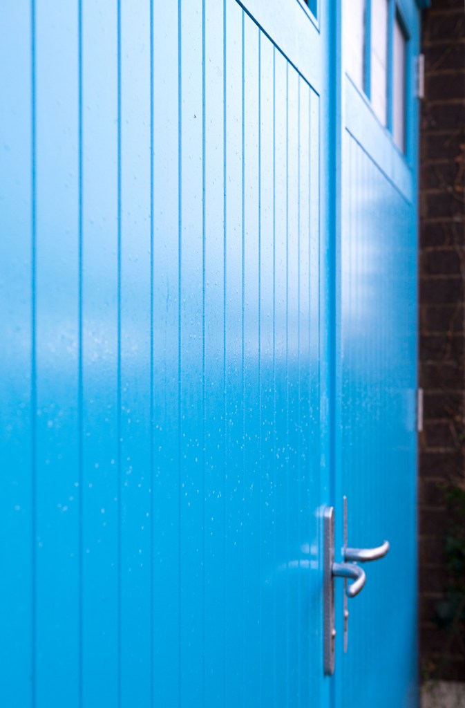 side view of a double blue door - silver door handles