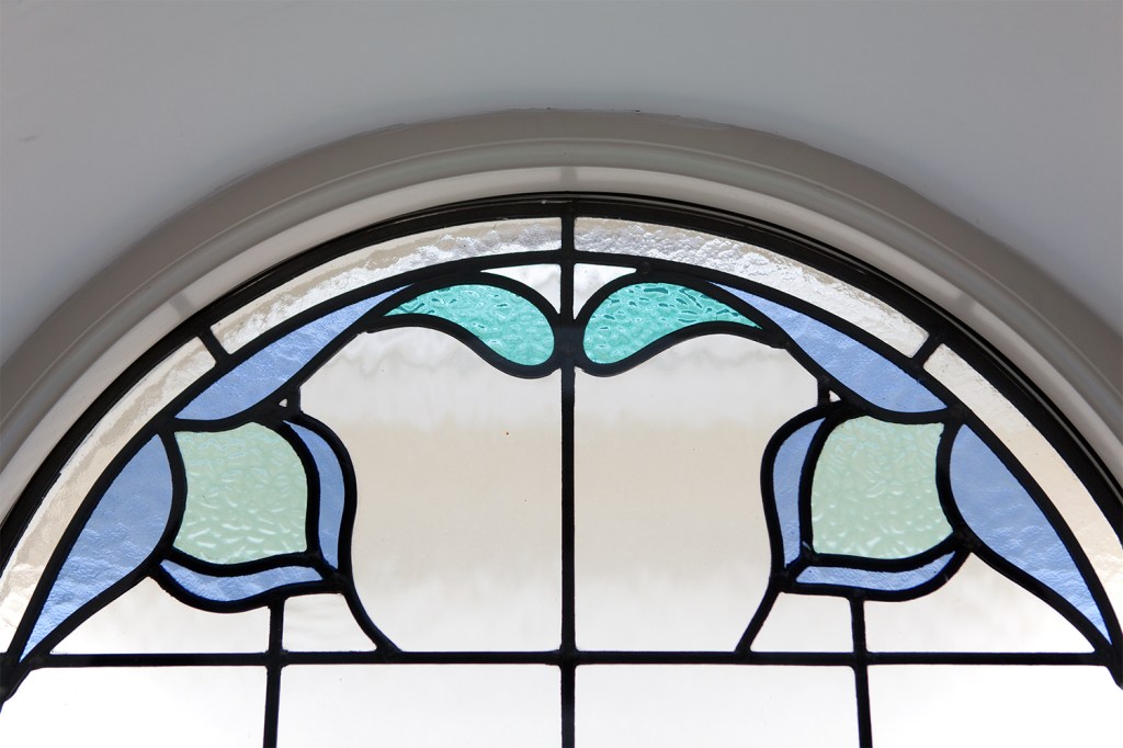 blue glass stained arched window - ceiling high arched window - blue glass art