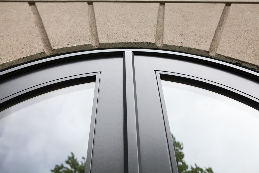 Arched black transom door - brick arch - black door frame
