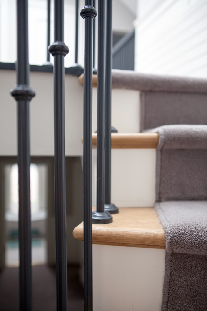 Wooden stairs with carpet - thin black railing