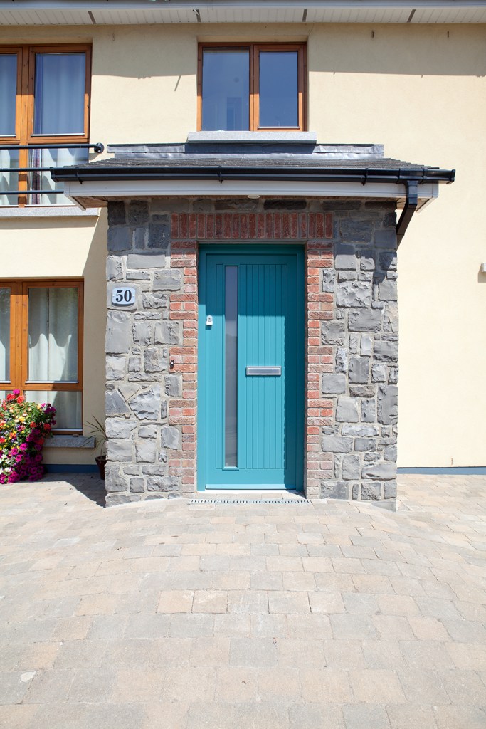Turquoise door - stone wall - red brick arch