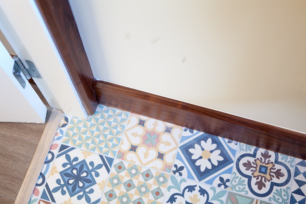 Wood frame and skirting with a mosaic tiled floor