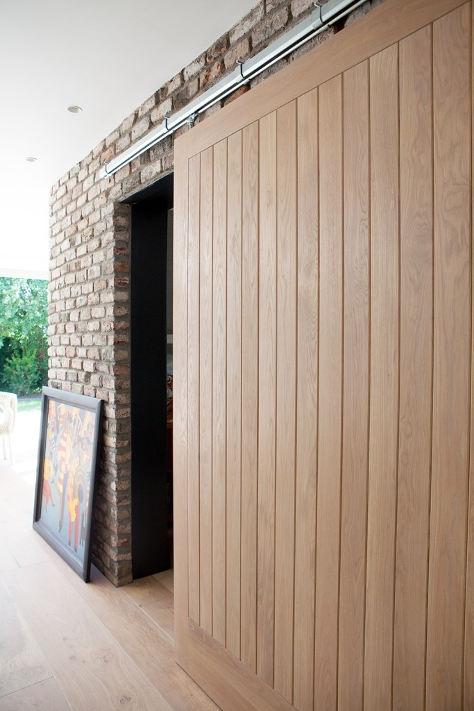Sliding door open - view from outside - brick wall - white ceiling - portrait