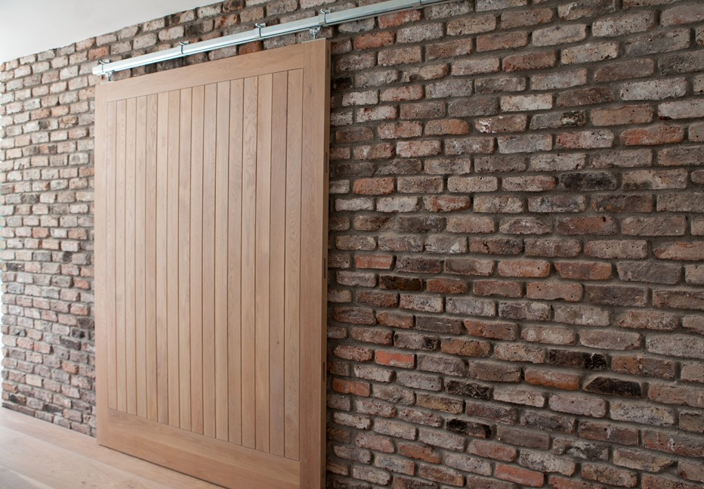 Sliding wood door with brick wall