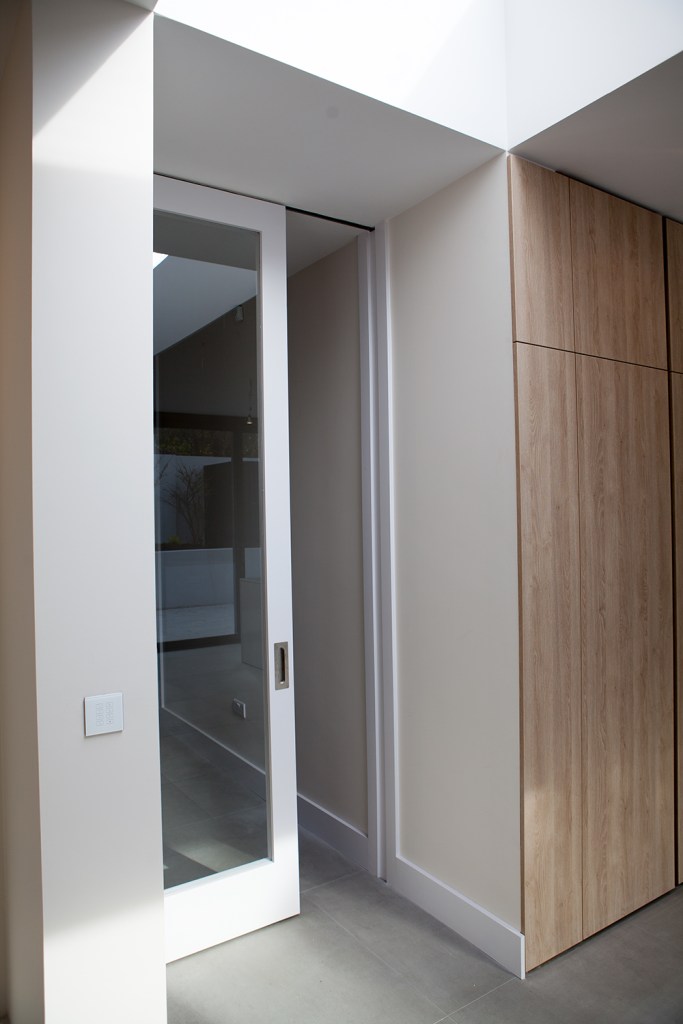 Glass door - glass sliding door - hallway with door - white door frame - flush door