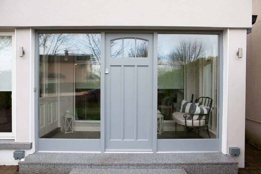 Grey transom door with big sidelights on the side of the door - sun room - front entrance room - natural light