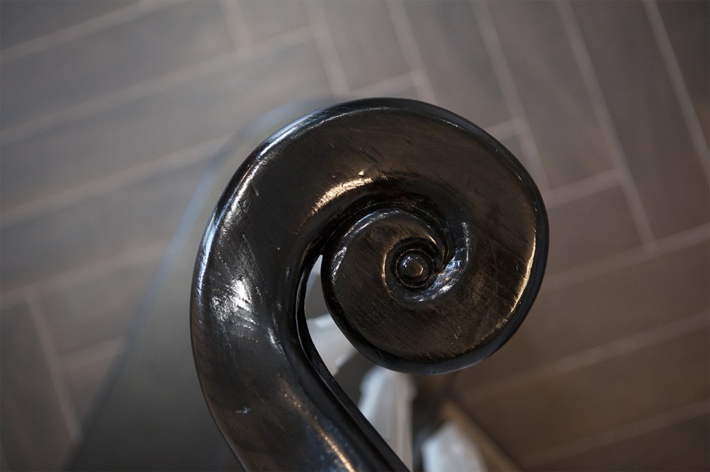 Carved staircase handrail end - staircase end detail - carved wood detail - newel cap