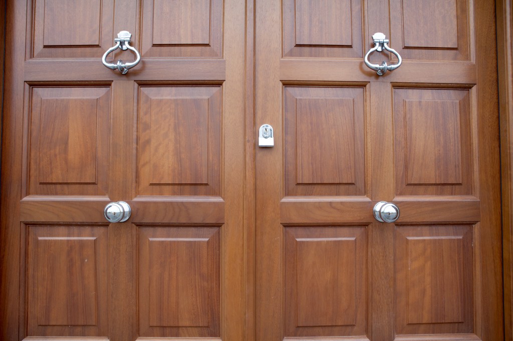 Double door - wood door - silver door handles and knockers - key hole
