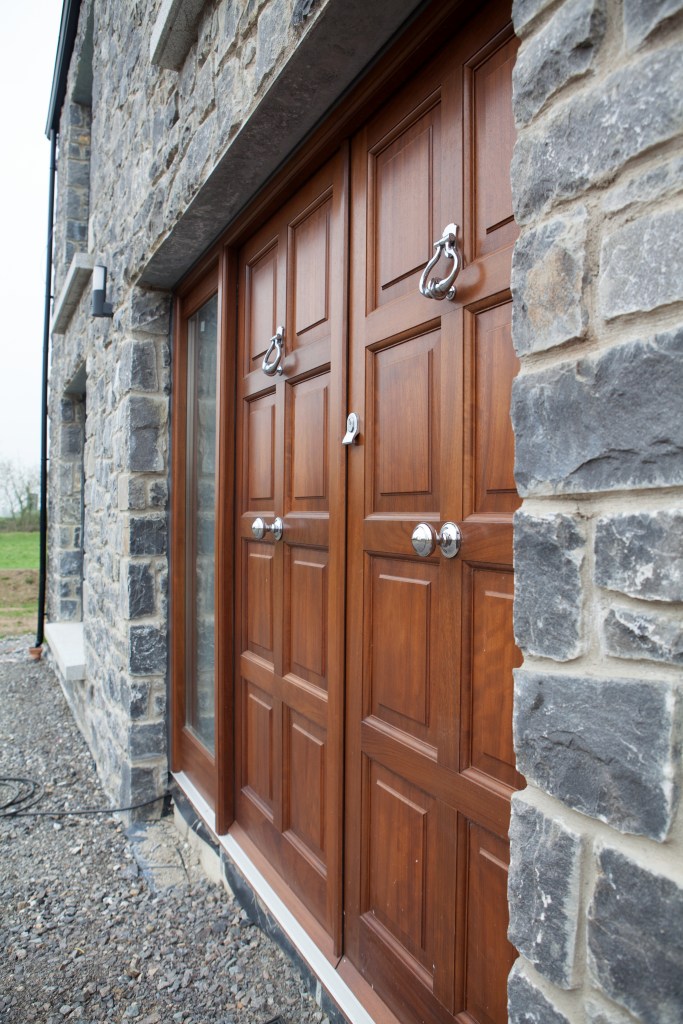 Wooden door - side view - brick wall - silver door knob